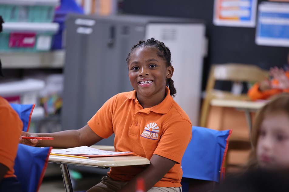 students and teacher working in classroom